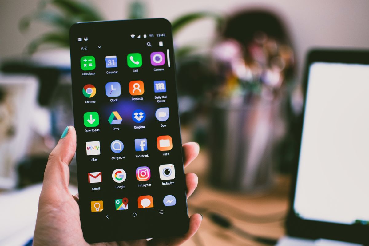 A phone full of apps held in one hand