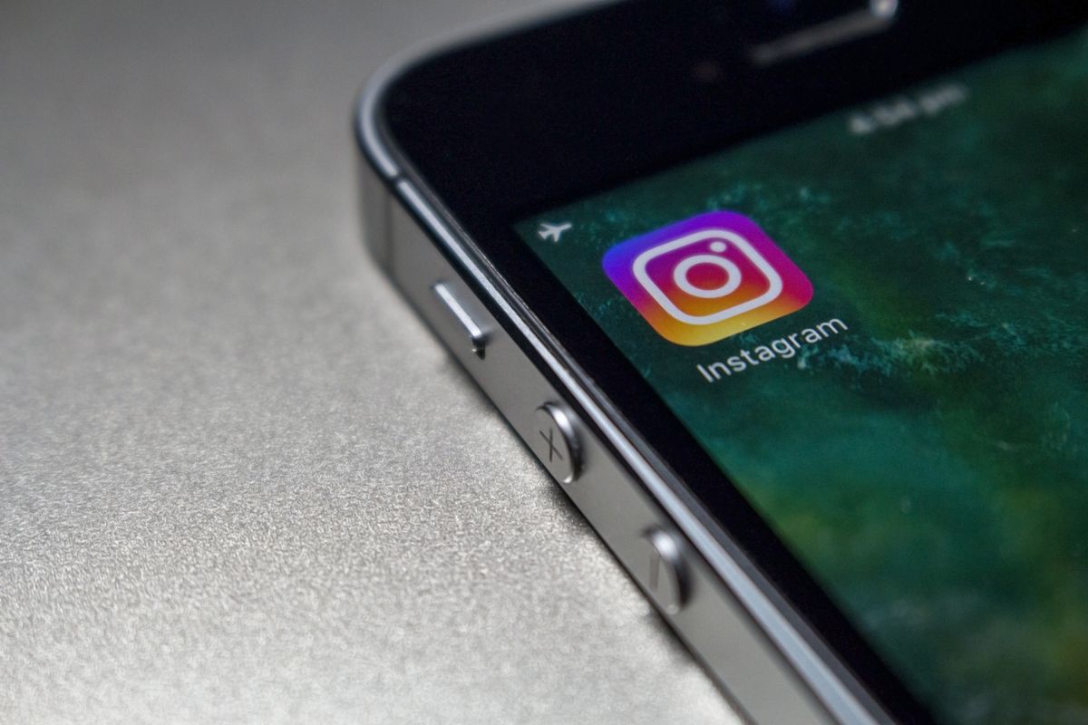 The Instagram app icon on a phone screen, up close