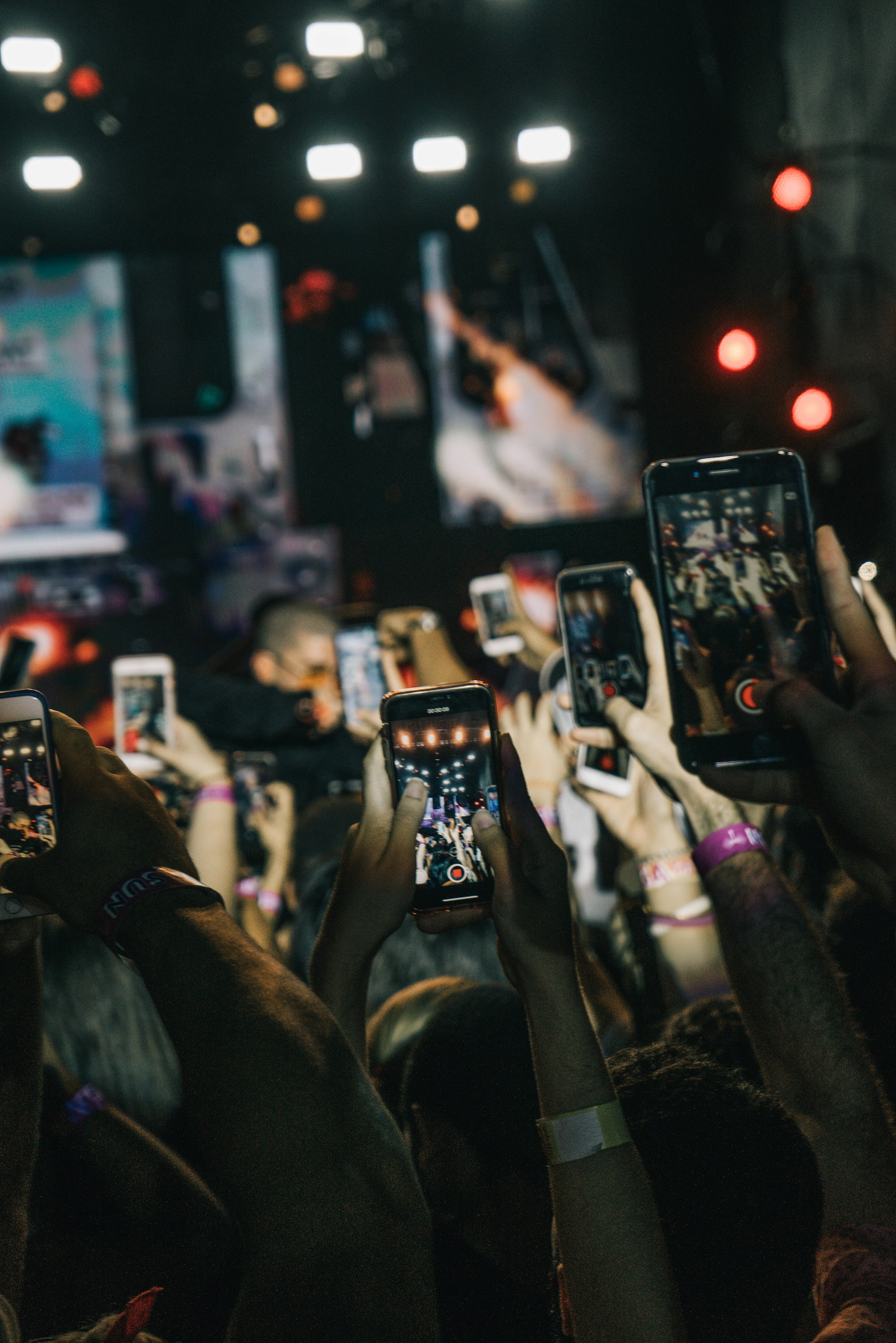A crowd of raised phones, everyone filming