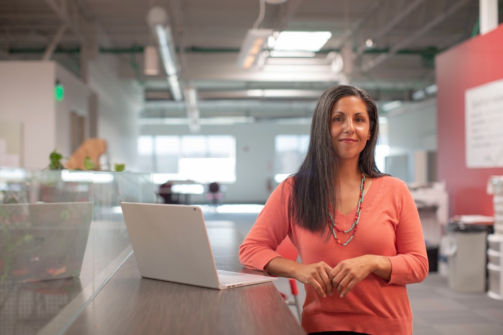 A coach teaching through her laptop at a standing desk